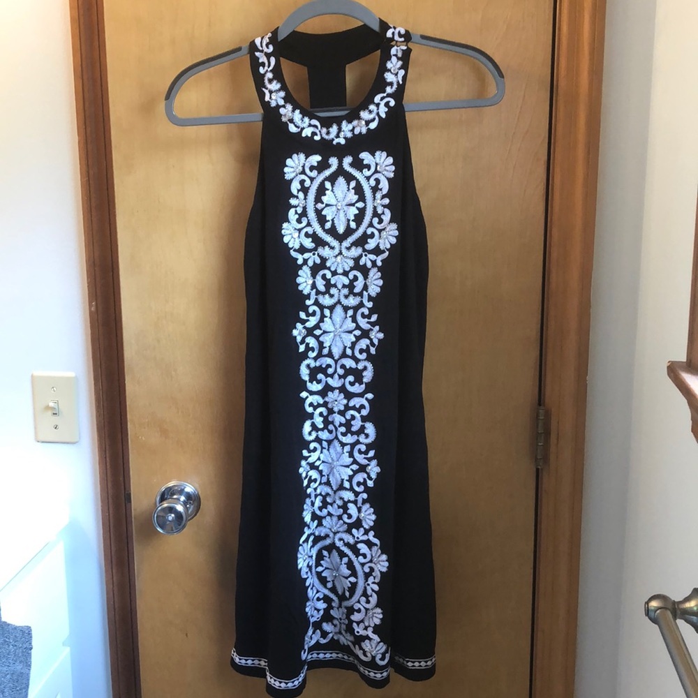 Black mini dress with white embroidered details